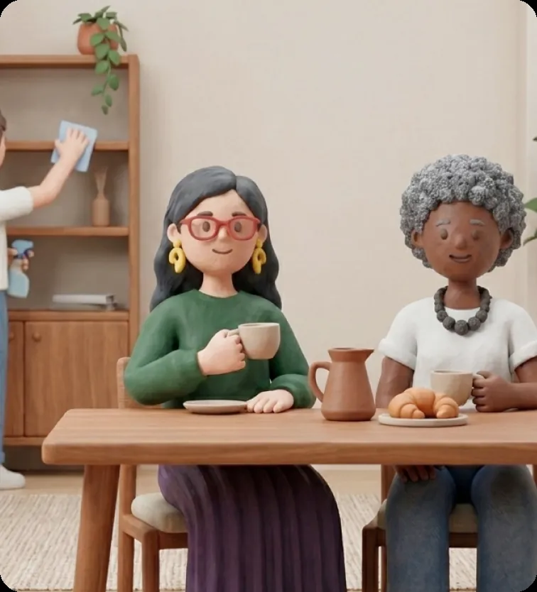 A clay-style granddaughter and her nana sharing a cup of tea at the kitchen table.